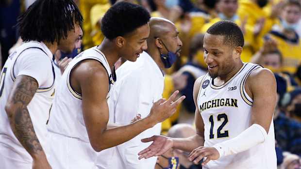 Michigan's DeVante' Jones celebrates with teammates
